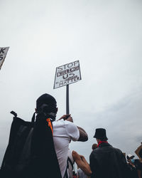 Rear view of people against sky