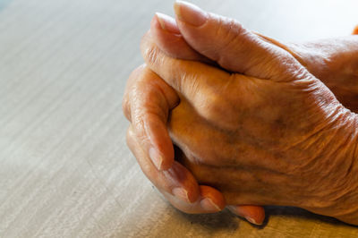 Close-up of human hand on table