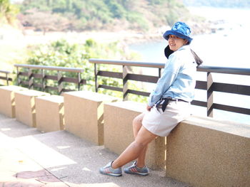 Side view of boy on railing