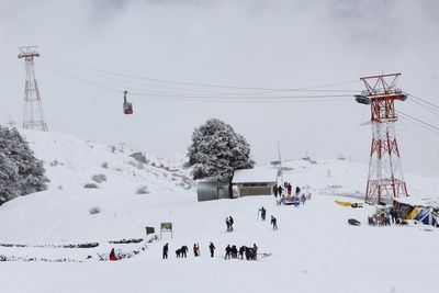 Overhead cable car against sky during winter