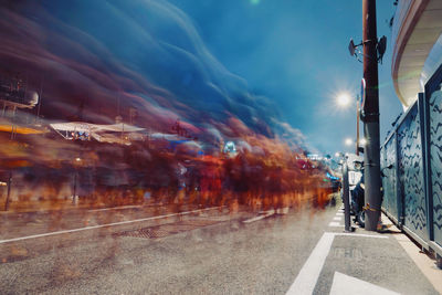 Blurred motion of man walking on street in city