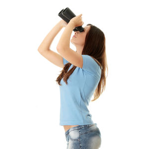Woman photographing against white background