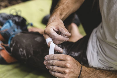 Close up of rock climber hands taping up fingers