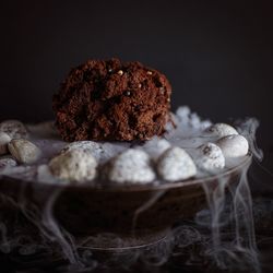 Close-up of cake on table against black background