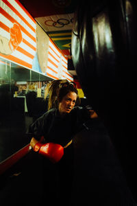 Rear view of young woman standing in gym