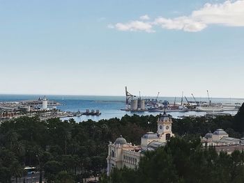 High angle view of buildings by sea against sky