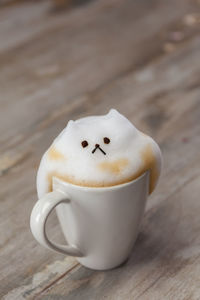 Close-up of mug with froth on table