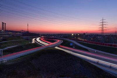 High angle view of light trails on road against sky during sunset