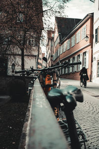 People on street amidst buildings in city