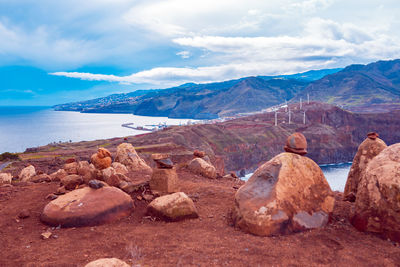 Scenic view of rocks and sea against sky