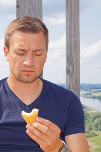 Man looking at snack against sky