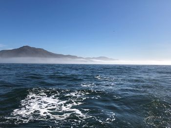 Scenic view of sea against clear blue sky