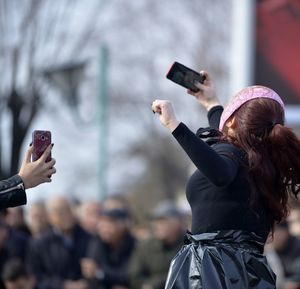 Rear view of person photographing