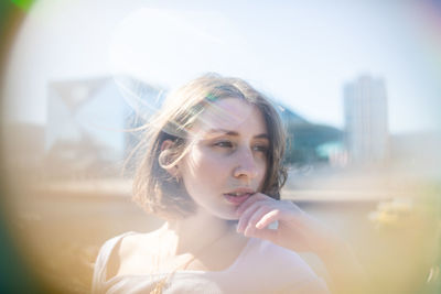 Portrait of young woman smoking outdoors