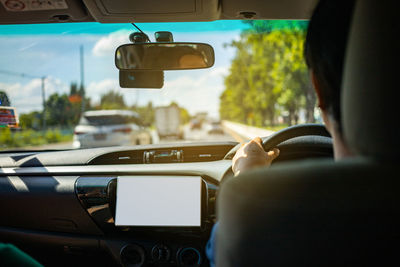 Rear view of man driving car