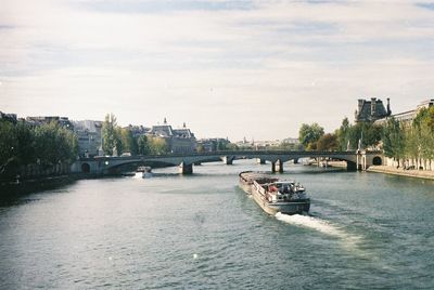 View of bridge over river against cloudy sky