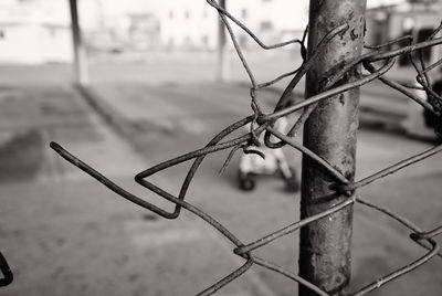 Close-up of barbed wire on fence