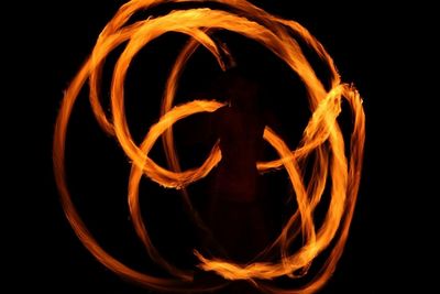 Close-up of illuminated fire against black background