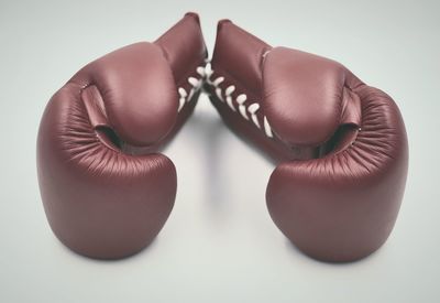 Close-up of shoes on table against white background