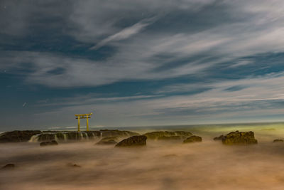 Built structure on beach against sky