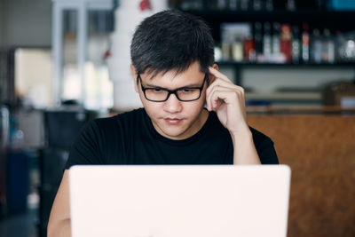 Portrait of young man using smart phone