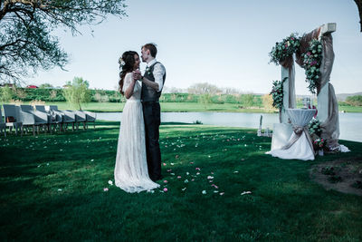 Couple dancing on lawn during wedding ceremony