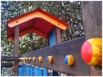 Low angle view of railing against trees