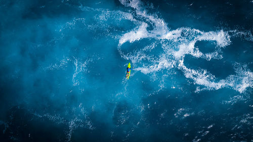 Aerial view of man surfing in sea