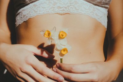 Midsection of woman holding flower bouquet