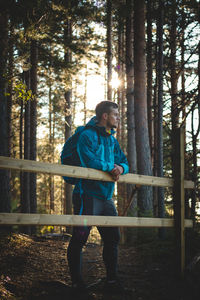 Rear view of man standing in forest