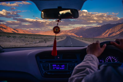 Midsection of man in car against mountain range