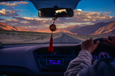 Cropped image of man driving car