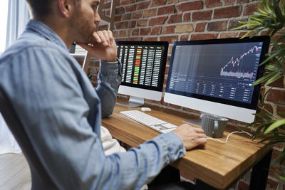 Midsection of businessman working at office