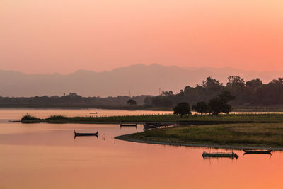 Scenic view of lake against sky during sunset