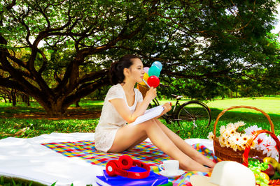 Full length of woman sitting in park