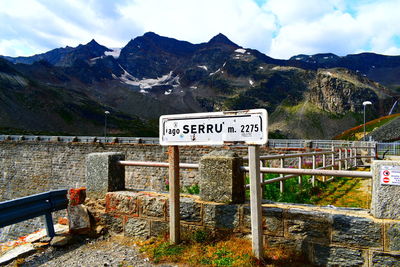 Information sign on landscape against sky