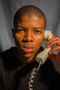 Close-up portrait of man talking on telephone