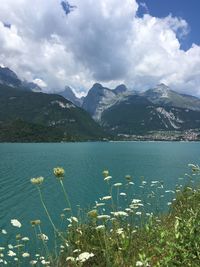Scenic view of lake by mountains against sky