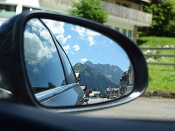 Reflection of road in side-view mirror of car