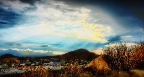 Scenic view of mountains against cloudy sky