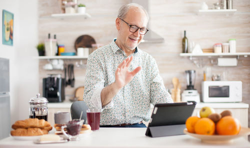 Man doing video call in kitchen at home