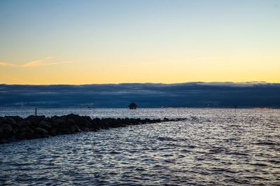 Scenic view of sea against sky during sunset