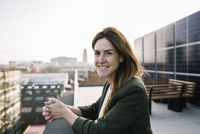 Mid adult woman standing at building terrace