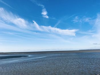 Scenic view of sea against blue sky