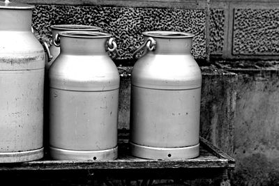 Close-up of old metal container against wall