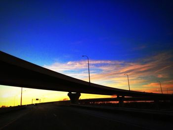 Cars on road at sunset