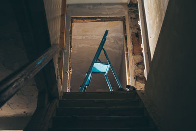 Low angle view of step ladder in abandoned home
