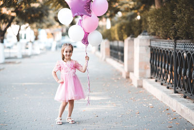 Young woman holding balloons