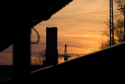 Silhouette of suspension bridge during sunset