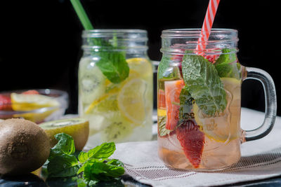 Close-up of drink in glass over water against gray background